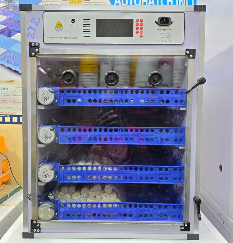 Cabinet incubator with blue egg-turning trays and digital controller