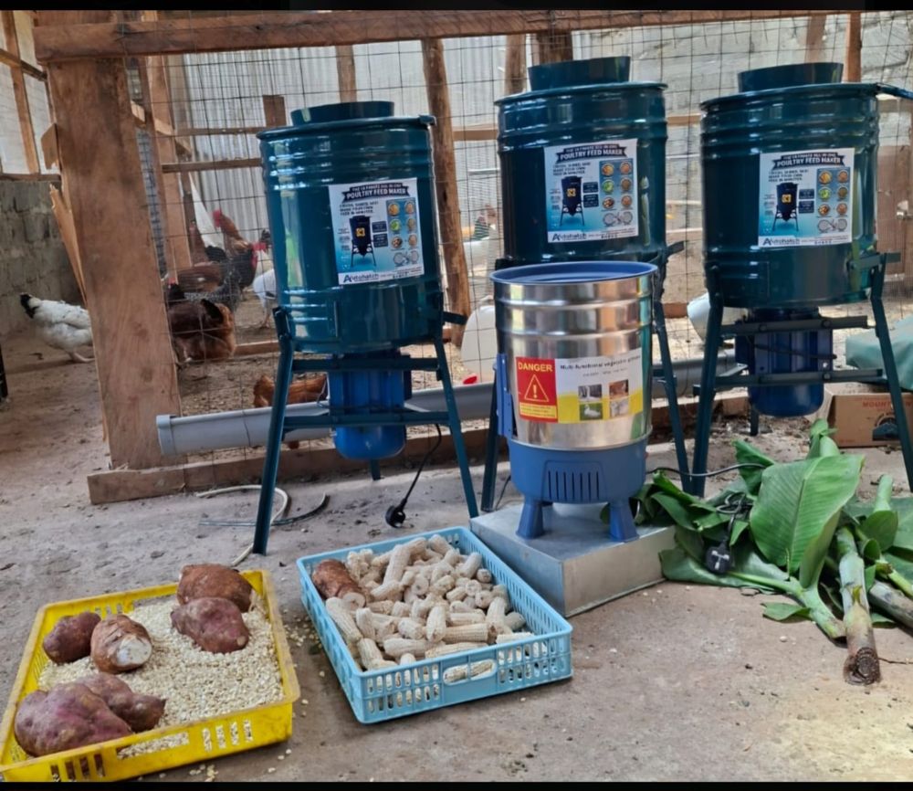 Three Autohatch Poultry Feed Maker machines and a vegetable grinder on a farm
